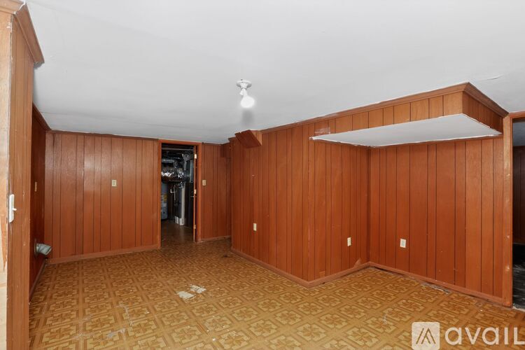 A room with wooden walls and a patterned floor.