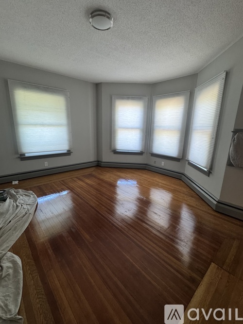 A room with wooden flooring and a white door.