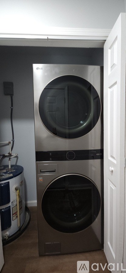 A modern stainless steel dishwasher and washing machine are installed in a kitchen.