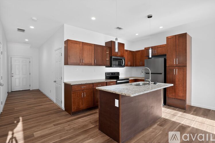 A kitchen with wooden cabinets and a white island.