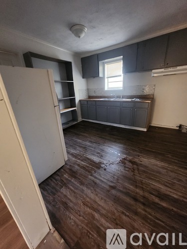 A room with wooden floors and a white door.