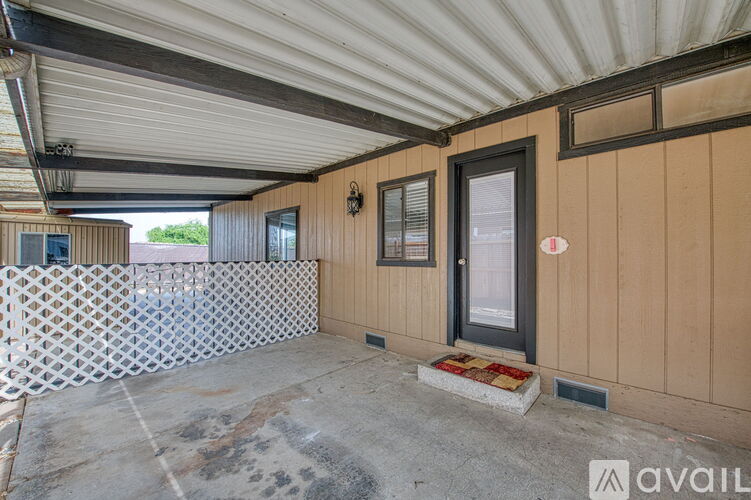 A room with a corrugated metal roof and wooden walls.