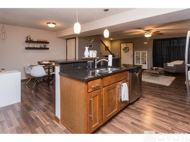 A kitchen with wooden cabinets and a black countertop.