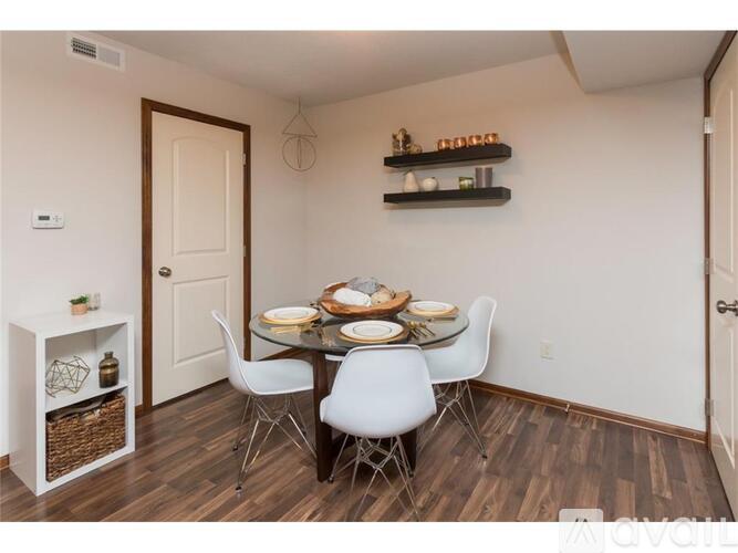 A dining room with a white table and chairs.