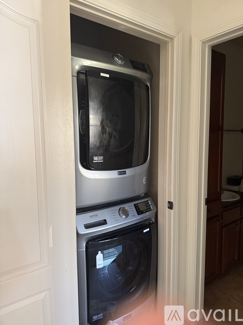 A stacked dishwasher and oven in a kitchen.