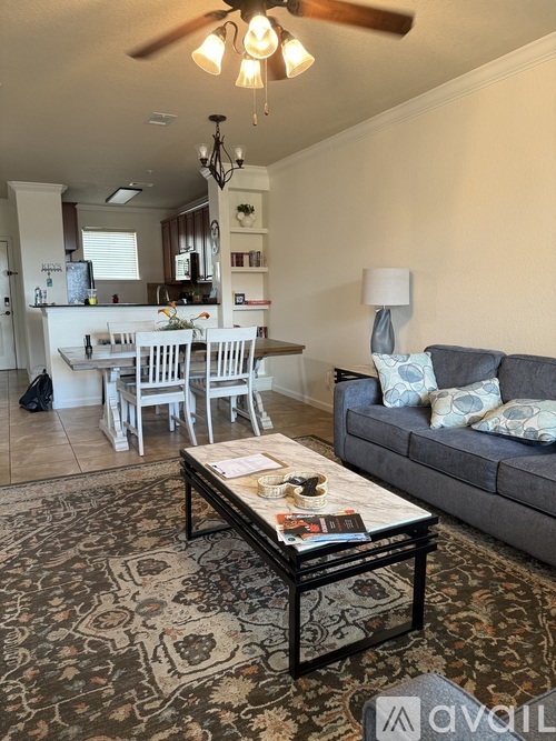 A living room with a grey couch and a coffee table.
