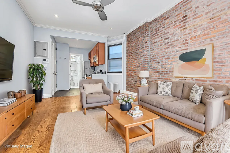 A living room with a brick wall and a couch.