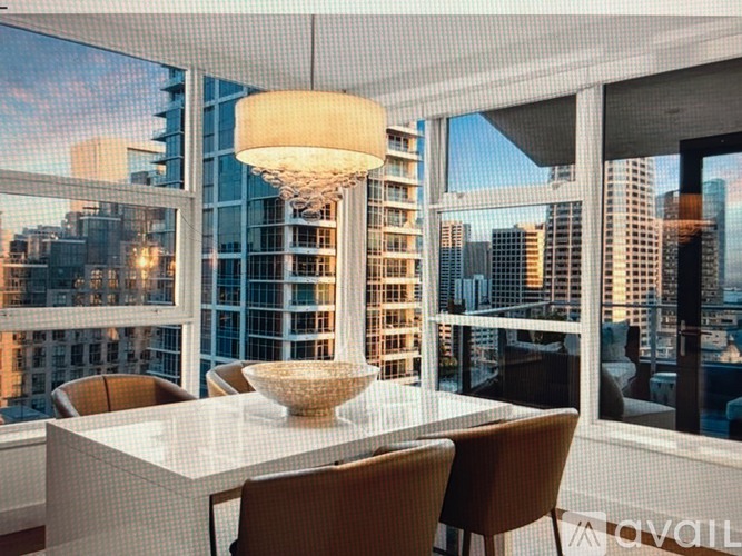 A modern dining room with a view of the city skyline.