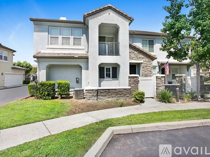 A house with a stone pillar in front of it.
