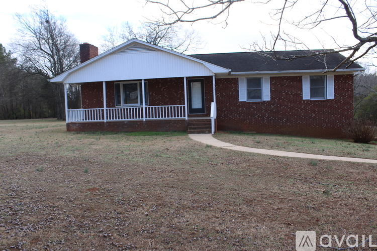 A small house with a porch and a covered front door.