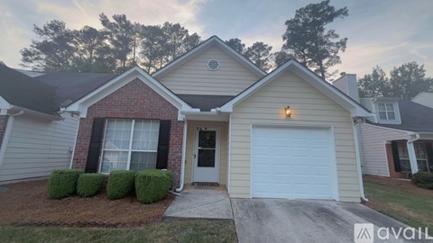 A house with a red door and a white garage door.