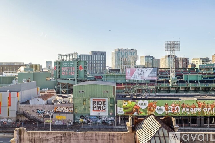 A cityscape with a large billboard that says "RIDE PMC" and "104M" on it.