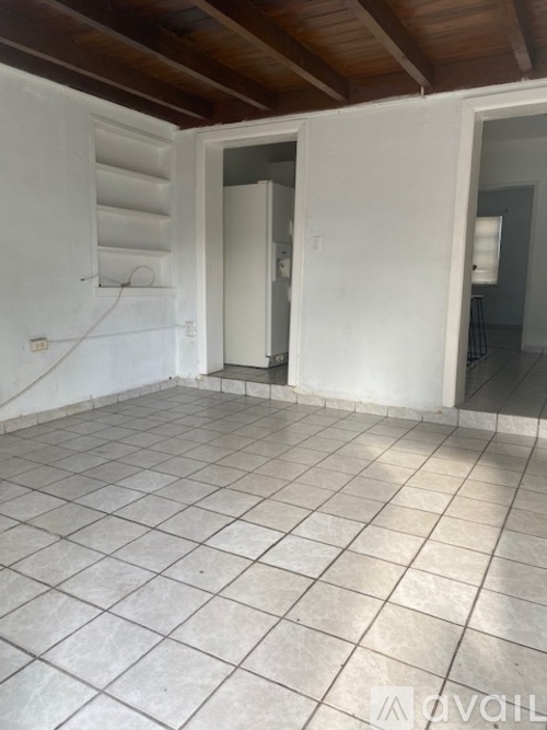 A room with white walls and a tiled floor.