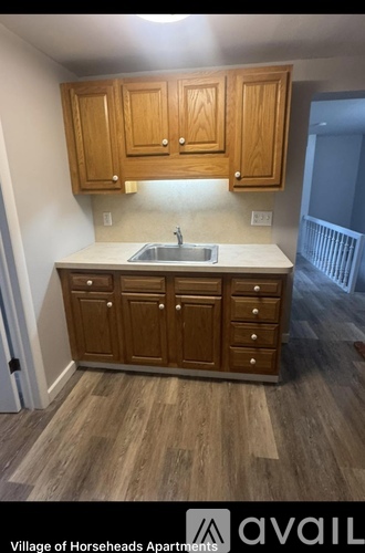 A kitchen with wooden cabinets and a sink.