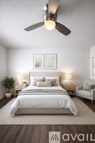 A bedroom with a large bed, a ceiling fan, and two nightstands with lamps.