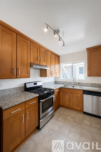 A kitchen with wooden cabinets and a granite countertop.