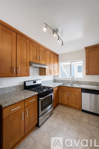 A kitchen with wooden cabinets and a granite countertop.