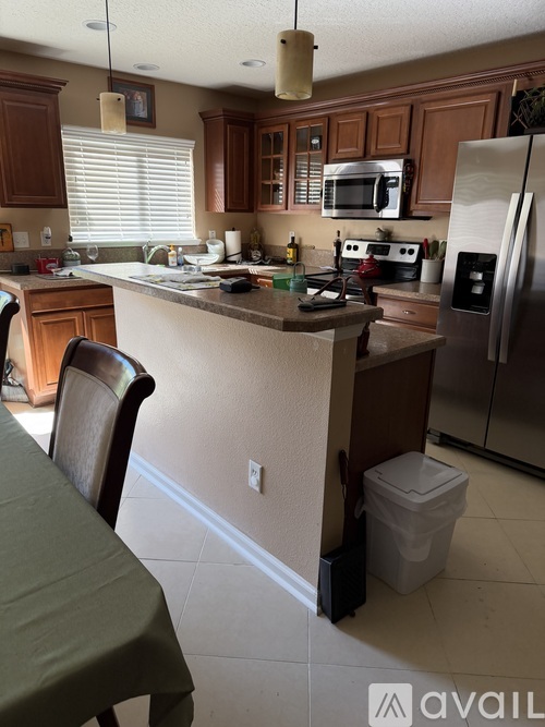 A kitchen with a table and chairs in it.