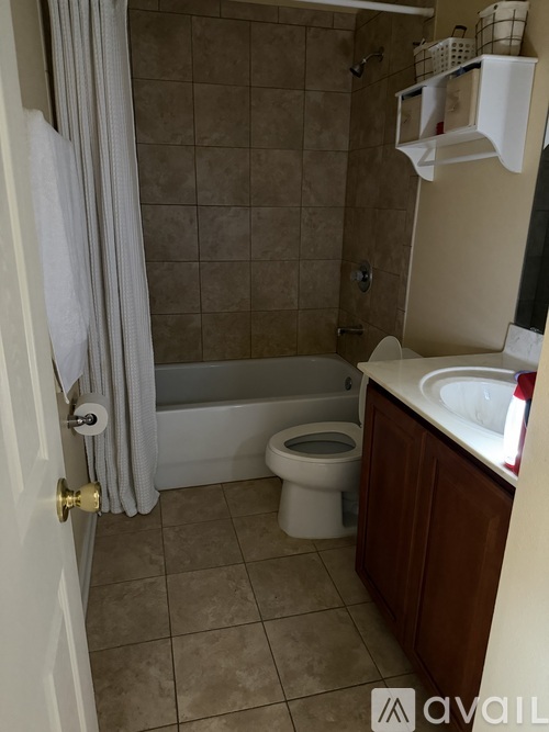 A bathroom with a toilet, sink, and bathtub.