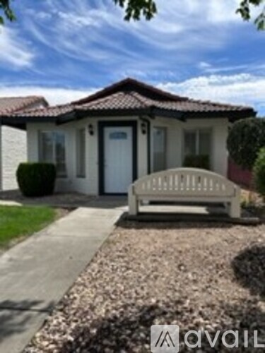 A house with a white door and a bench in front.