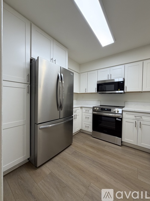 A kitchen with a stainless steel refrigerator and oven.