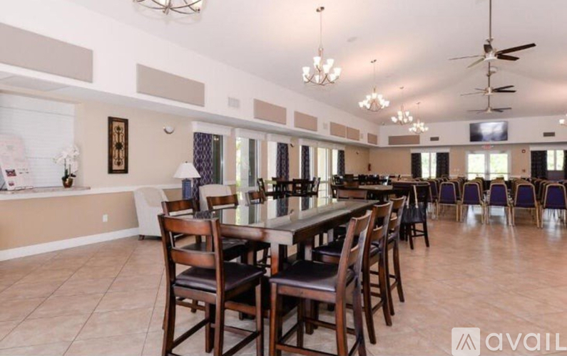 A dining room with a long table and chairs.
