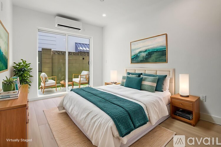 A bedroom with a large bed and a painting on the wall.