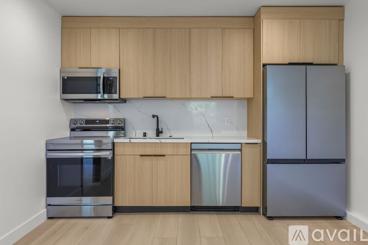 A kitchen with wooden cabinets and stainless steel appliances.