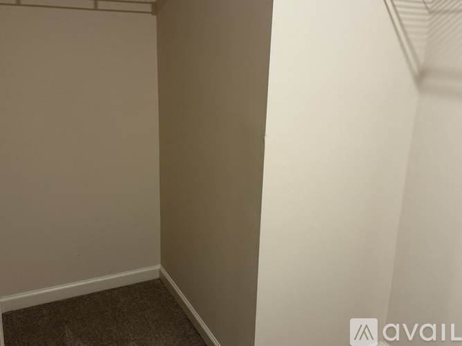 A room with a carpeted floor and white walls.