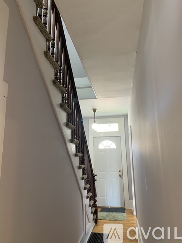 A staircase with a light blue carpet on the floor.