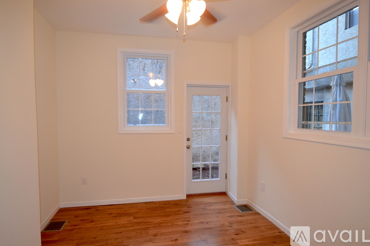 A room with a wooden floor and a ceiling fan.