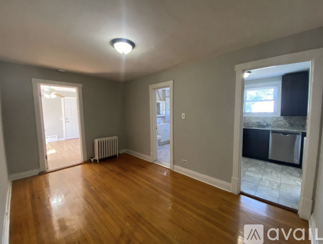 A room with wooden floors and a ceiling light.