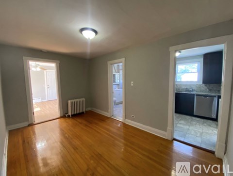 A room with wooden floors and a ceiling light.