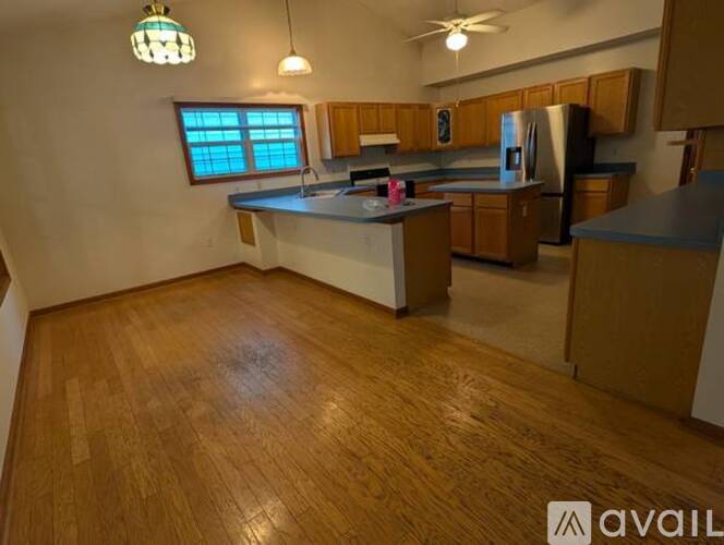 A kitchen with wooden floors and a window.