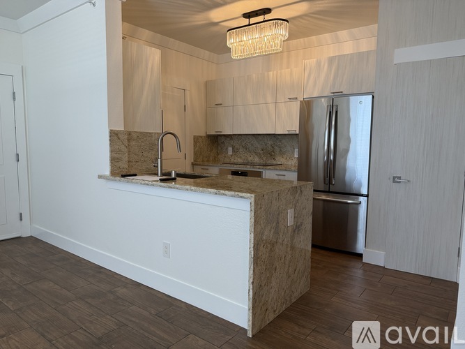 A kitchen with a wooden island and stainless steel appliances.
