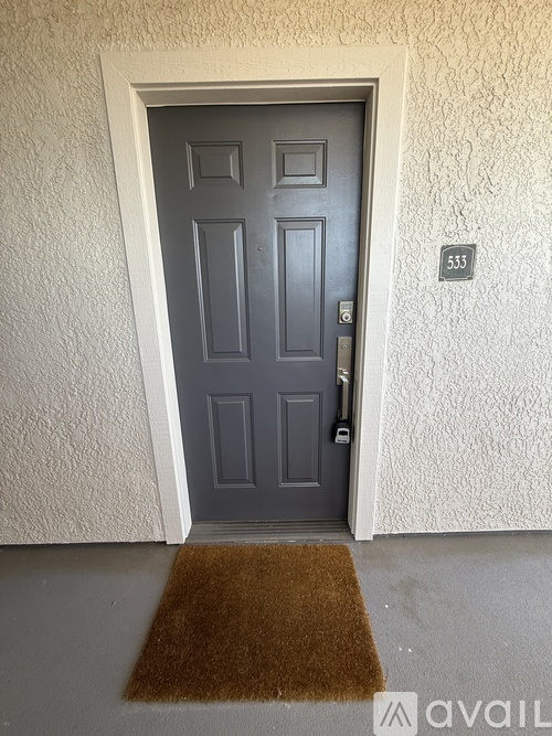 A grey door with a number 535 on the wall above it.
