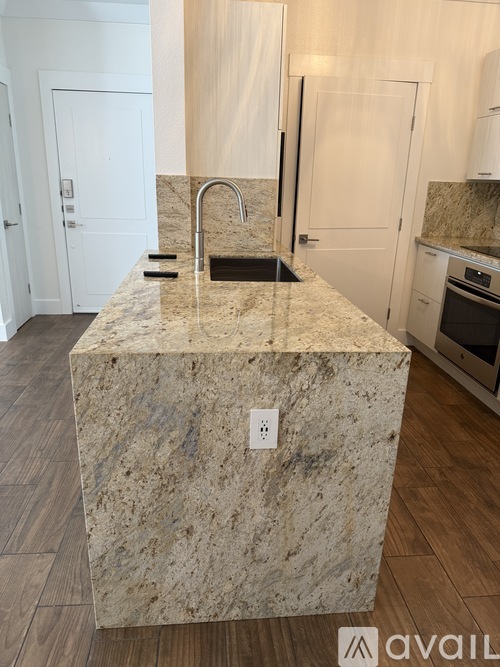 A kitchen island with a sink and a faucet.