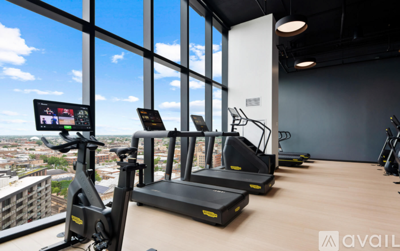 A gym with treadmills and a view of the city.