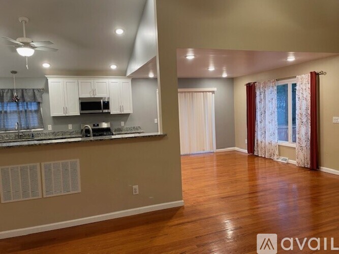A kitchen with a counter and cabinets is available for rent.