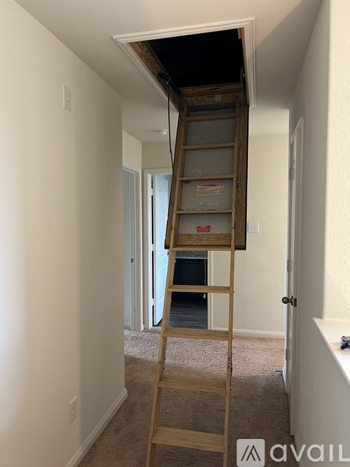 A wooden ladder is leaning against a wall in a room.