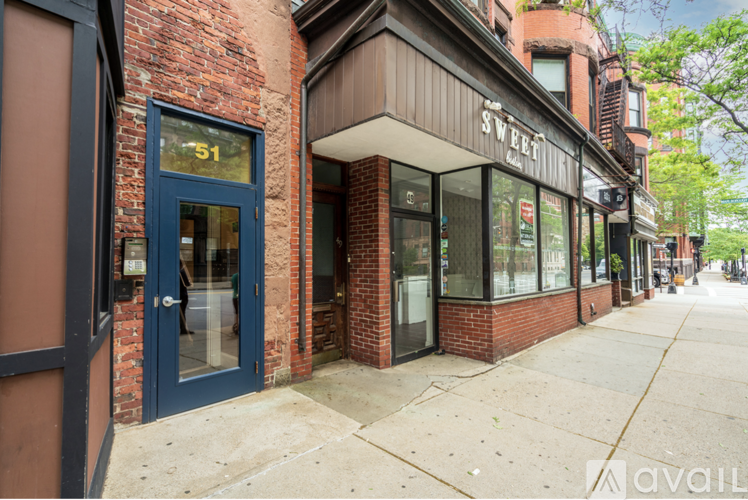 A building with a blue door and windows is labeled Sweet.
