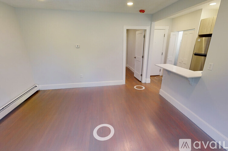 A room with wooden floors and white walls.