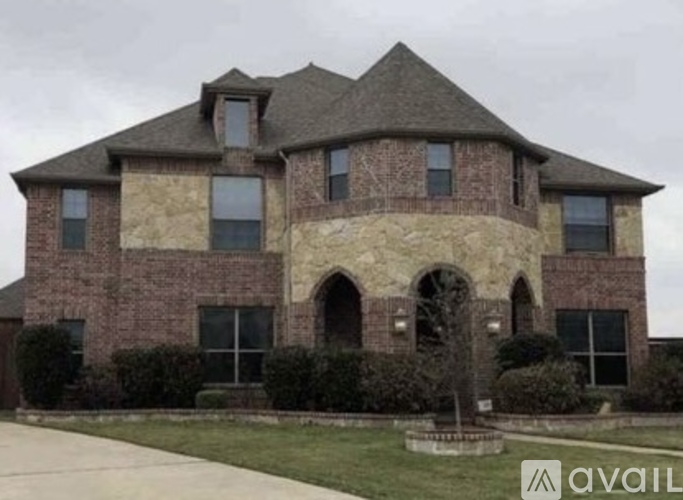 A large house with a stone archway entrance.