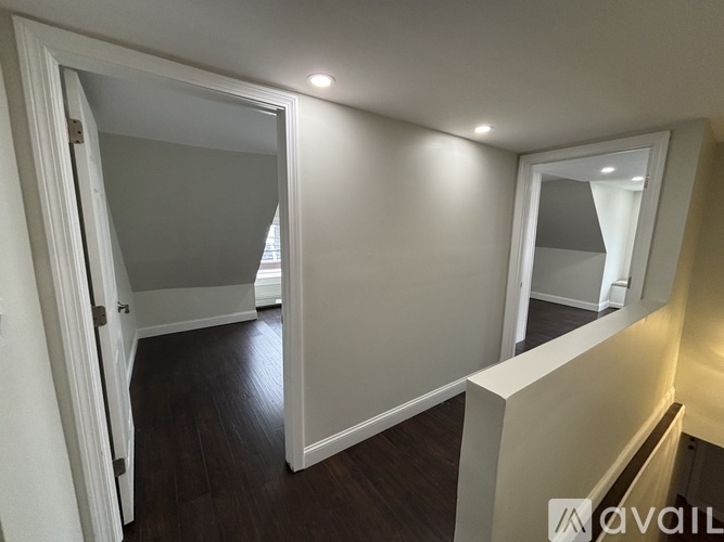 A room with a door and a mirror on the wall.