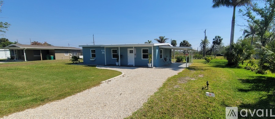 A gravel path leads to a small building with a sign that says "available" in front of it.
