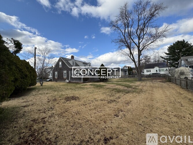 A field with a house and trees in the background with the words "CONCEPT PROPERTIES" written on the house.