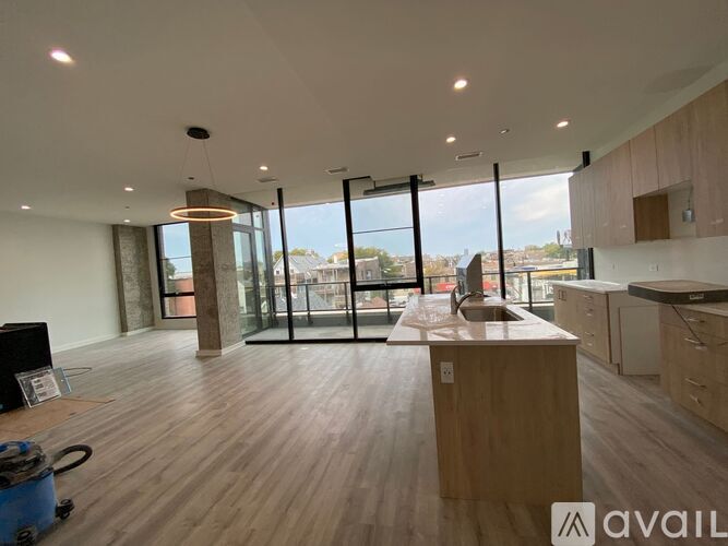 A modern kitchen with wooden floors and a large island in the middle.