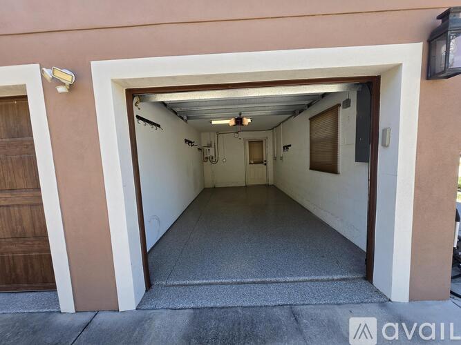 A long hallway with a carpeted floor and white walls.