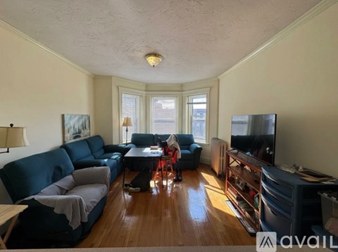 A living room with a blue couch and a television.