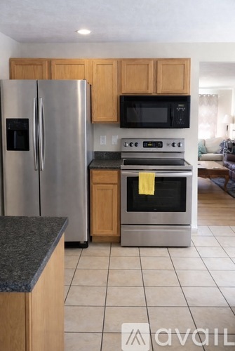 A kitchen with a stainless steel refrigerator and oven.